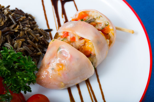 Image of stuffed squid with wild rice and cherry tomato
