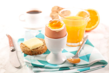 breakfast with boiled egg, coffee and orange juice
