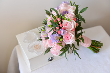 A beautiful fresh bridal bouquet of fresh roses lies on the table. wedding floristry, floristic decorative statement