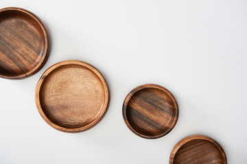 top view of wooden bowls on white background