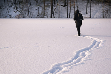 The tired, exhausted traveler. Footprints in the snow. Frost