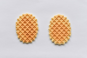 A stack of golden round waffles isolated over white background.