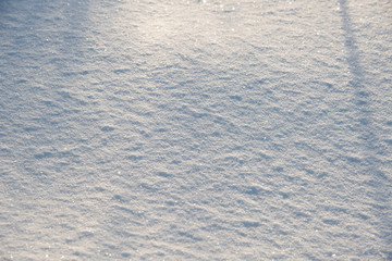 the natural background - snow surface in sunshine