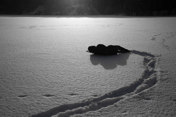 The tired, exhausted traveler fell into the snow and needs the help of lifeguards. The man fell...