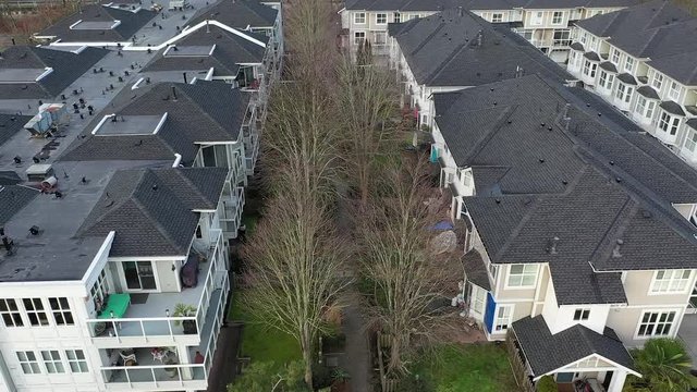 A perfect neighbourhood. Houses in suburb at Summer in the north America. Luxury houses with nice landscape. Aerial drone view. 4K.