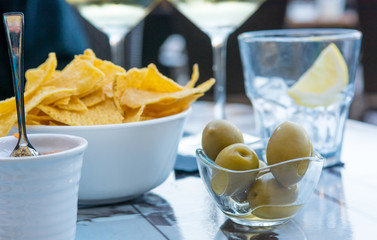 Outdoor street cafe table with finger food and local wine.