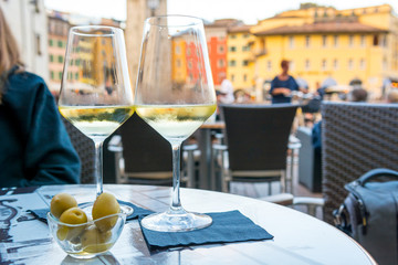 Outdoor street cafe table with finger food and local wine.