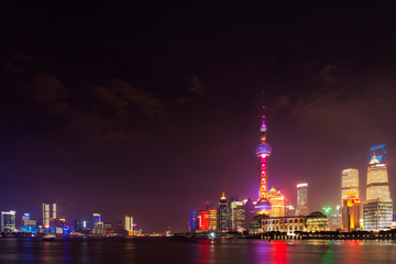 Obraz na płótnie Canvas Modern city skyscrapers of Shanghai skyline at night with reflection of beautiful ligth in Huangpu river view from the bund, Shanghai, China