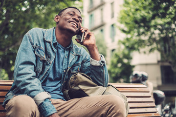Young african-american with mobile phone outdoors