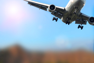plane flies in the blue sky against the backdrop of a mountain landscape, flies away