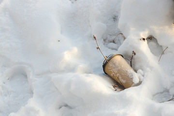 paper Cup for hot drinks, covered with snow in the snow background.