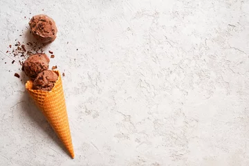 Gordijnen Background with balls of chocolate ice cream in the waffle cone © alinakho