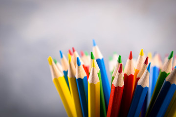 Pencils colorul color wooden pencil in metal holder in front of wall background