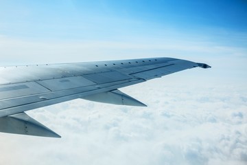 Airplane Wing Out of Window with Clouds and Sky