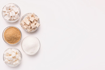 Various kinds of sugar cubes, pieces ands sand