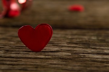 Fototapeta premium Heart shape decoration on wooden plank