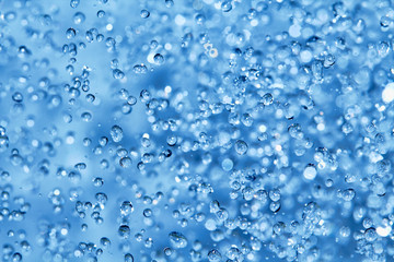 Blue water drops background in closeup.
