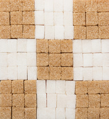 White and brown sugar cubes creative background