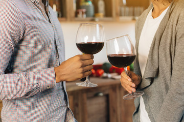 Happy couple celebrating and cheering with glasses of wine