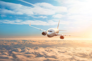 Passenger plane, business trip, travel concept. Flying evening sunset.