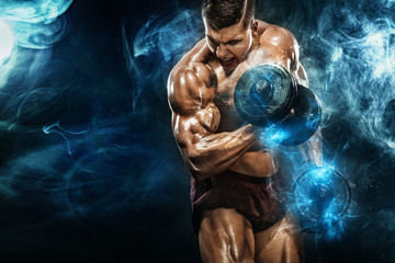 Fototapeta Brutal strong muscular bodybuilder athletic man pumping up muscles with dumbbell on black background. Workout bodybuilding concept. Copy space for sport nutrition ads. obraz