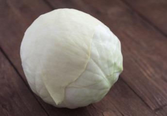 head of white cabbage on wooden background