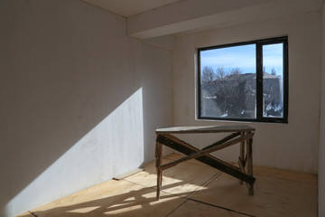 Interrior of a room in a building under construction with sunlight