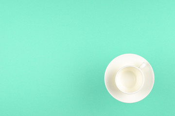 Empty cup on green background