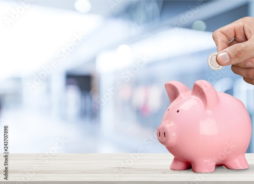 Man Putting Coin In Pig Moneybox Stock Photo And Royalty Free - man putting coin in pig moneybox