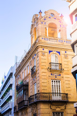 Obraz premium Traditional facades of houses with twisted forged balconies of the city of Seville, Andalusia Spain