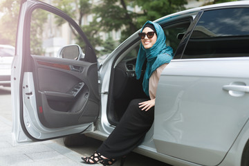Muslim lady wearing hijab in her car.
