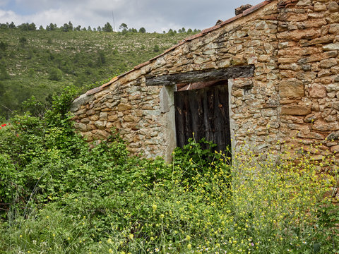 Facade of an old abandoned house in the mountains of Enguera, Spain