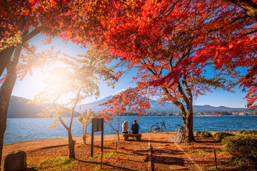 Mt. Fuji over Lake Kawaguchiko with autumn foliage and couple love at sunrise in Fujikawaguchiko,...