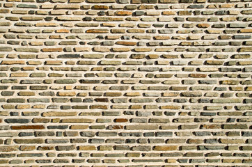 New cement plaster with rows of stones closeup