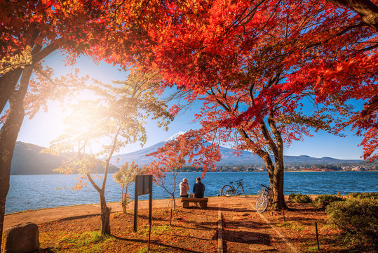 Mt. Fuji over Lake Kawaguchiko with autumn foliage and couple love at sunrise in Fujikawaguchiko, Japan.