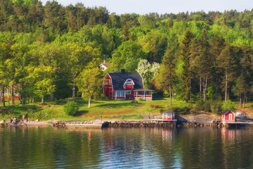 Finland, small red houses on an island in the Baltic Sea