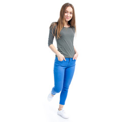 Woman in jeans and white sneakers goes on white background isolation