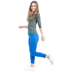 Woman in jeans and white sneakers goes on white background isolation