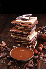 Chocolate bars on table with chocolate tower.