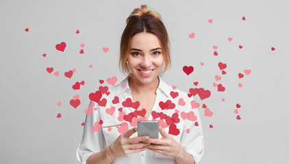 Love message for Valentine day - hearts flying out smartphone in girls hands - obrazy, fototapety, plakaty