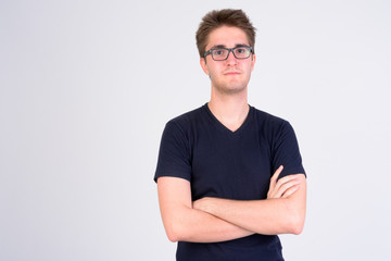 Young handsome man wearing eyeglasses with arms crossed