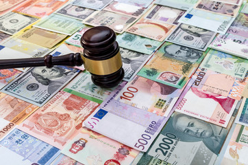 Judge hummer on various banknotes background close up