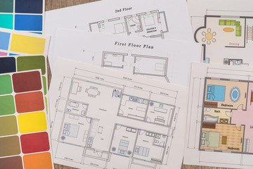 Different house plans with colour palette on table