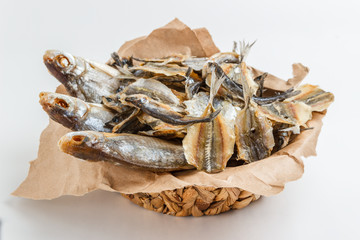 Assorted dried fish in a basket on craft paper