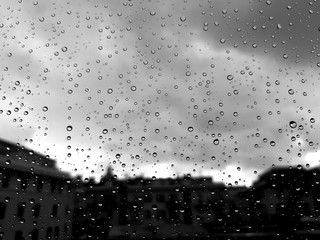 Genova, Italy - 10/28/2018: An amazing photography of some waterdrops over the window after summer rain in the city