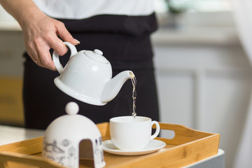 female pouring tea