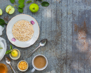 oatmeal, oat flakes, coffee for breakfast (table set). Top Food background