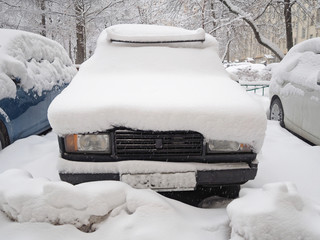 Snow covered car after heavy snowfall