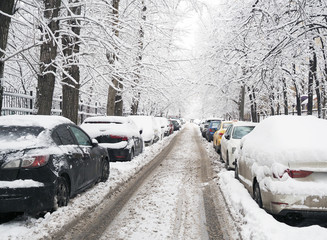 Snow covered street and cars after a heavy snowfall