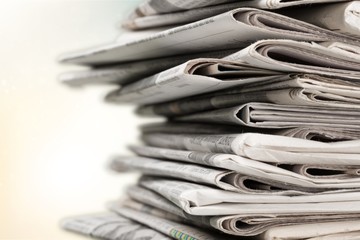 Pile of newspapers on white background